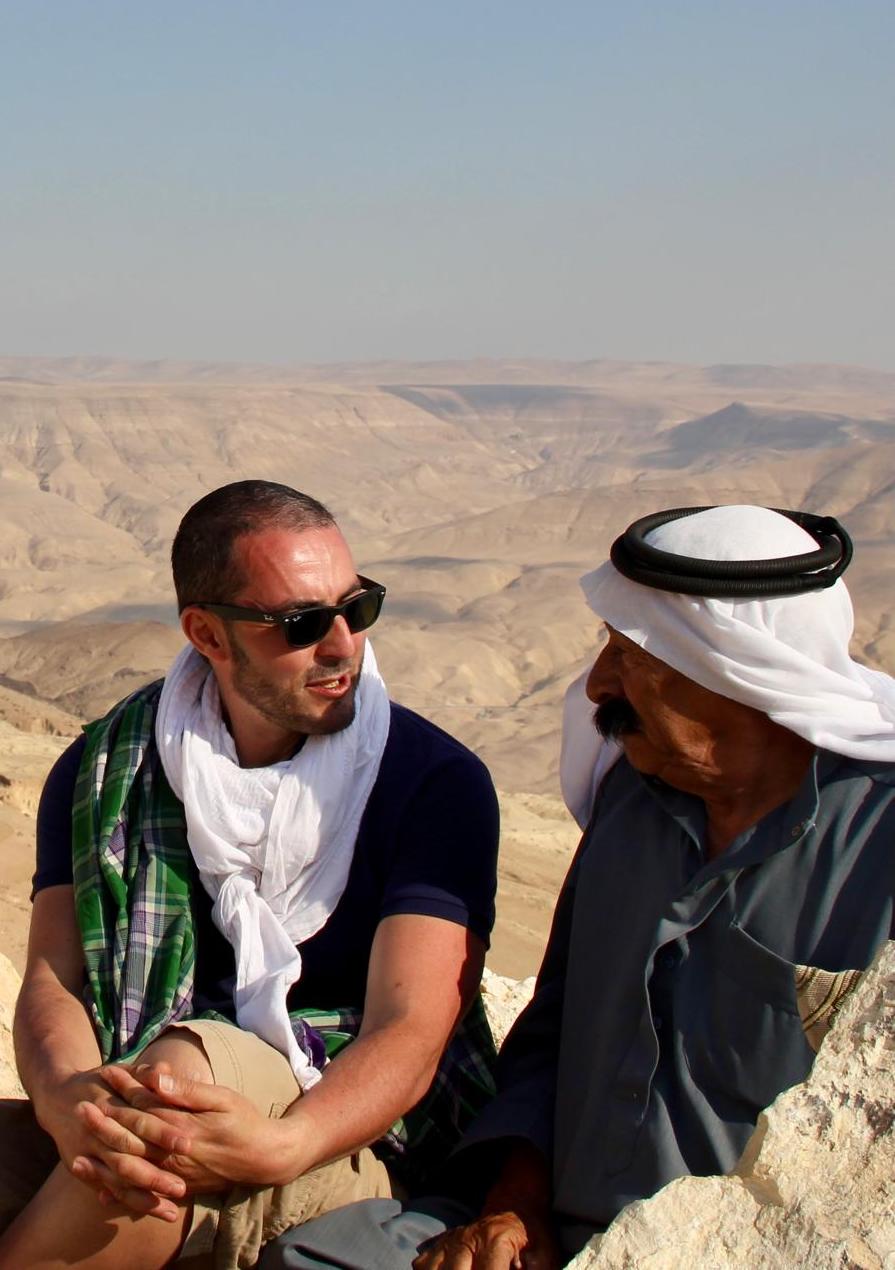 L’artiste échangeant avec un habitant local dans un paysage désertique en Jordanie